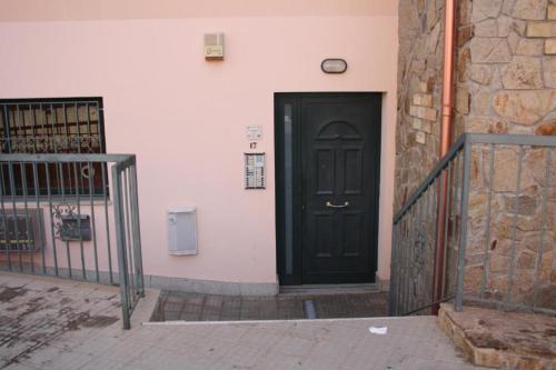 a black door on the side of a building at Da Nanni in Villasimius