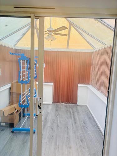 an empty room with a ceiling fan and a ladder at Goodness homes in Manchester
