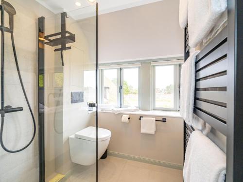 a bathroom with a toilet and a glass shower at Haus-Fahnert-1 in Kampen
