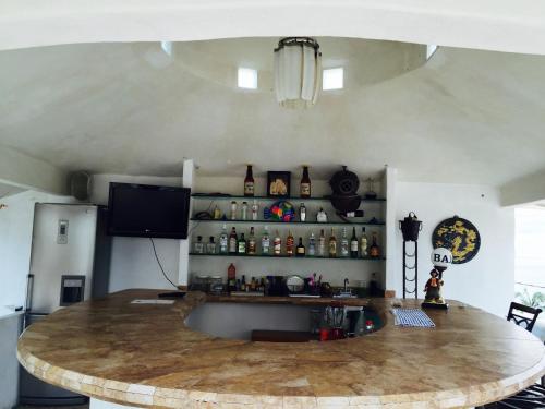 a kitchen with a large wooden table in a room at Villa Palmitas acogedor departamento nivel piscina gigante jardines in Acapulco