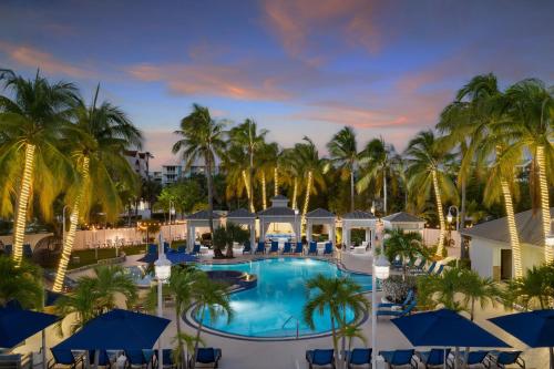 an aerial view of a resort pool with palm trees at DoubleTree by Hilton Grand Key Resort in Key West