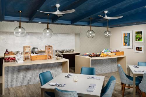 a restaurant with blue ceilings and tables and chairs at DoubleTree by Hilton Grand Key Resort in Key West