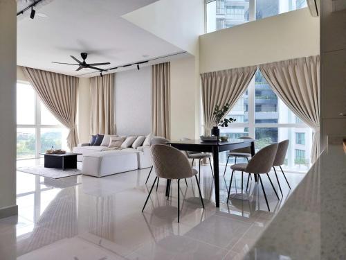 a living room with a white couch and a table at Luxury 4BR Duplex, Medini Apartment in Iskandar Puteri