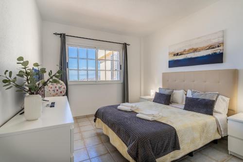 a bedroom with a bed and a window at Penthouse with ocean views - Torviscas in Adeje