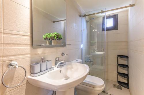 a bathroom with a sink and a toilet and a shower at Daya 2BR Apartment In Batroun in Batroûn