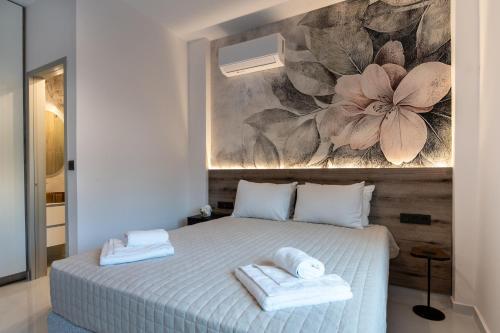 a bedroom with a bed with two towels on it at Lumera Urban Stay - New 2BR Home with Private Parking near Old Town in Chania