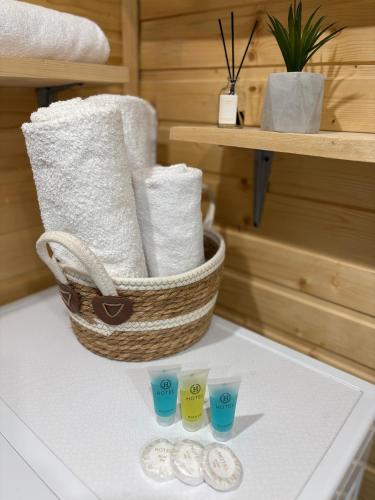 a basket of towels and cups on a table at Welcome Cottage in Kazbegi