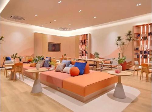 a living room with a couch and tables and chairs at Dcondo Reef Phuket in Kathu