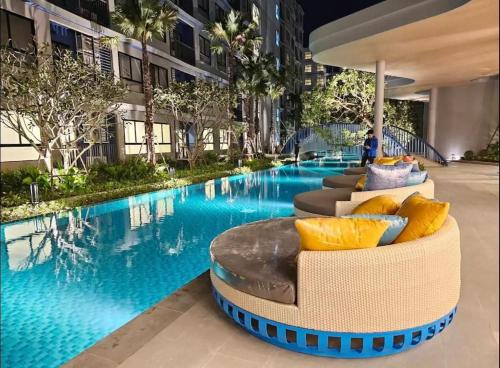 a swimming pool in a building with a hotel at Dcondo Reef Phuket in Kathu