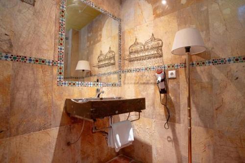 a bathroom with a sink and a mirror at Safestay Cordoba Mezquita Catedral in Córdoba