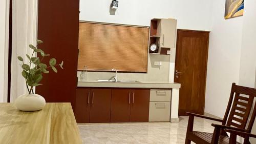 a kitchen with a sink and a table and a window at Opal Heights in Gampaha