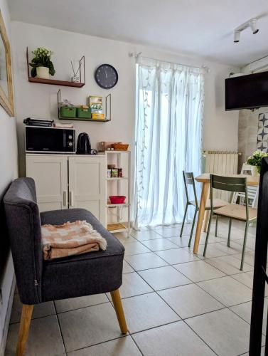 a living room with a chair and a table at L'angolino di Ale in Sulmona