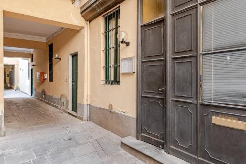 an empty hallway with two large doors on a building at AM15 - Design & Relax near the Navigli in Milan
