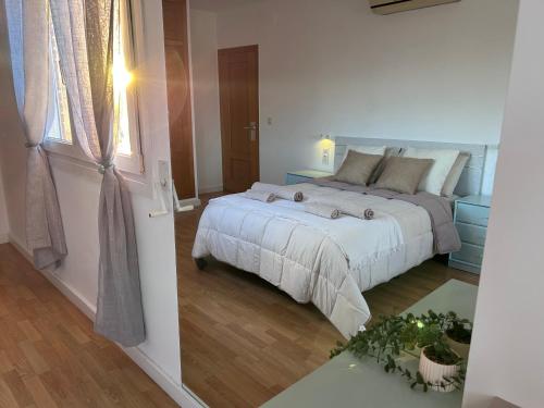 a bedroom with a large bed and a window at Baires&Blo Ático duplex, Terraza chillout exclusiva y vistas al mar in Benicarló