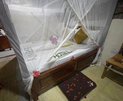 a bed with a canopy in a room at Serenity stay Kizimkazi in Kizimkazi