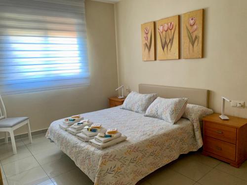a bedroom with a bed with a tray of food on it at Apartamento puerto Benicarlo in Benicarló