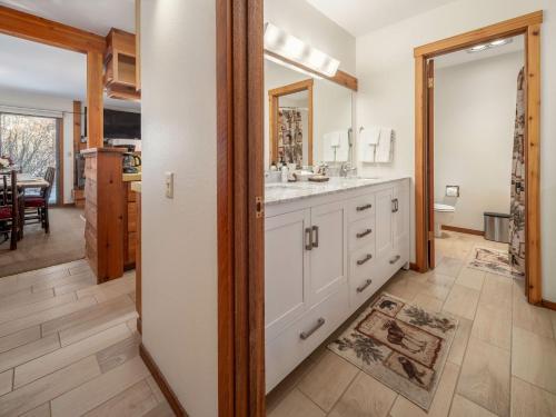 a kitchen with white cabinets and a sink at RMR: Chokeberry 3813 Condo in The Aspens in Wilson