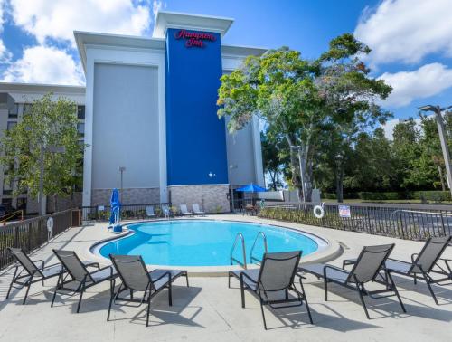 a pool at a hotel with chairs around it at Hampton Inn Tampa International Airport/Westshore in Tampa