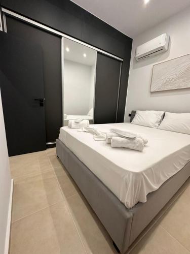 a bedroom with a large bed with towels on it at Helios 1 in Chios