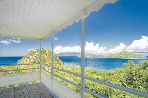 a porch with a view of the ocean at Villa Secrète du Pain de Sucre in Terre-de-Haut