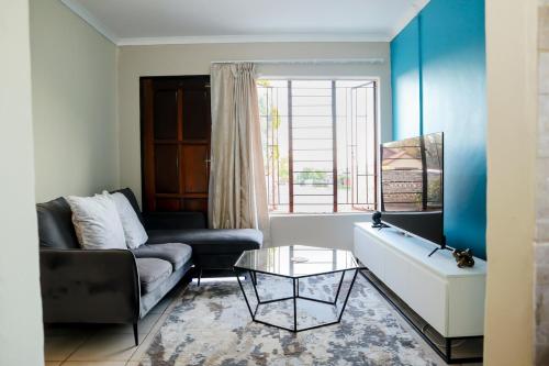 a living room with a couch and a table at Lapeng Mogwase Free Parking-Free WIFI in Mogwase