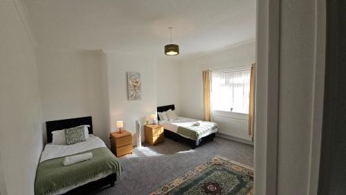a living room with two beds and a window at Ushaw HillTop View in Ushaw Moor