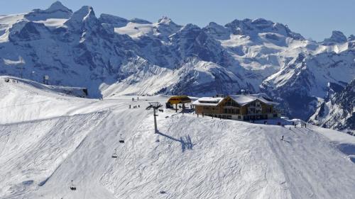 a ski lodge on top of a snow covered mountain at Ferienwohnung Stoos in Stoos