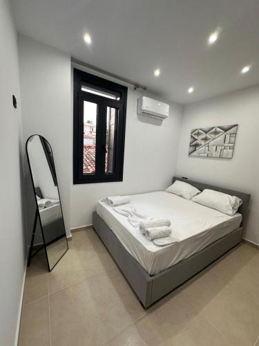 a bedroom with a bed and a chair in it at Helios 2 in Chios