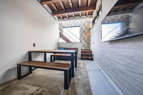 a room with two wooden tables and a staircase at DS2&3 - Vacation STAY 62445v in Tajiri