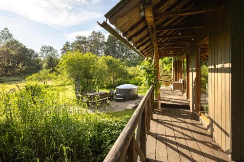 a porch of a house with a grill on it at Sauleskalns in Zaķumuiža