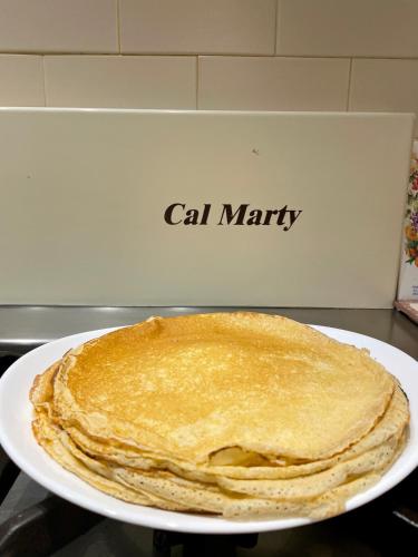 a stack of pancakes sitting on top of a plate at Chez Hélène 3 étoiles, labellisé disabled PMR,pour 4 personnes chiens bienvenus-pet friendly in Bourg-Madame