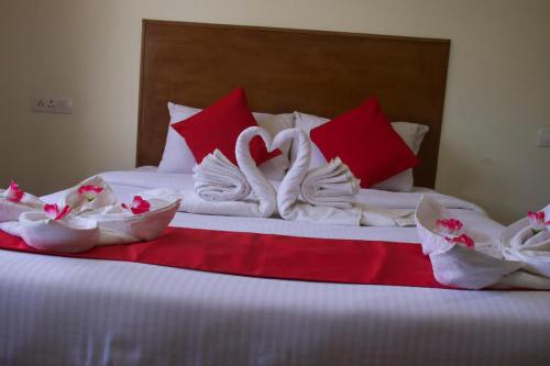 a bed with swans made out of towels on it at Life style home stay in Kodaikānāl