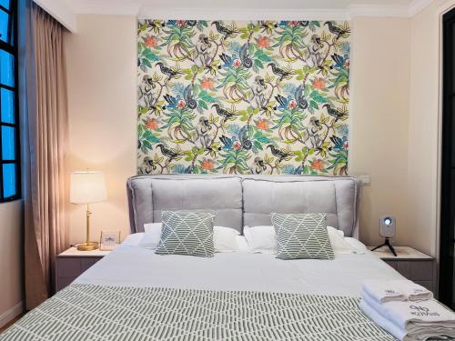 a bedroom with a large bed with a floral headboard at 梧舍壹号 外滩百年公寓B&B -Riverside Grace Suites on the bund and metro station in Shanghai