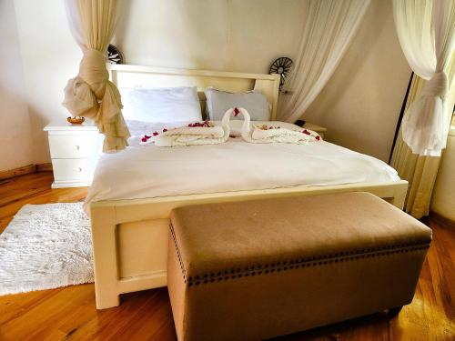 Una cama con dos cisnes encima. en Lilys Haven, en Malindi