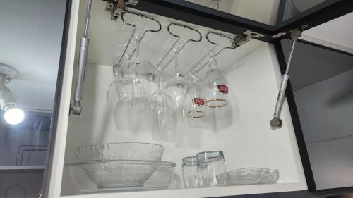 a shelf with glass bottles and other items on it at Apartamento com dois quartos a 300m da praia in Cabedelo