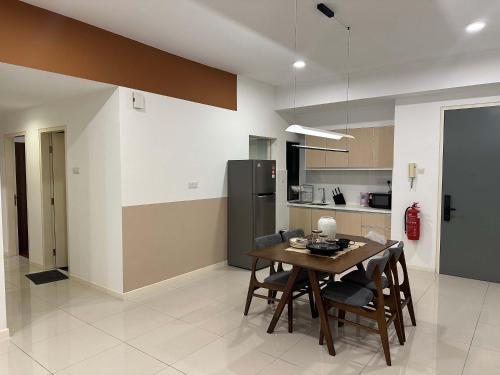 a kitchen and dining room with a table and chairs at The Jelutong Trio, Spacious 3-Bedroom Luxury Stay in Shah Alam