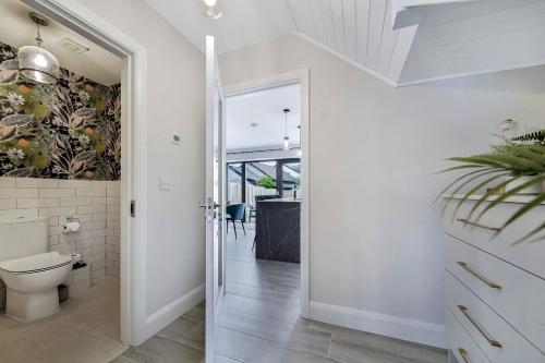 a white bathroom with a toilet and a hallway at No 30 at West Point Way Donegal Town in Donegal