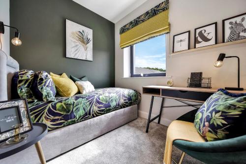 a bedroom with a bed and a desk in a room at No 30 at West Point Way Donegal Town in Donegal