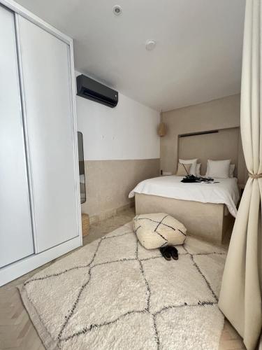 a bedroom with a bed and a large rug at Riad Manoury Marrakech - privates Boutique-Hotel für 6 in Marrakesh