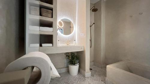a bathroom with a sink and a toilet and a mirror at Riad Manoury Marrakech - privates Boutique-Hotel für 6 in Marrakesh