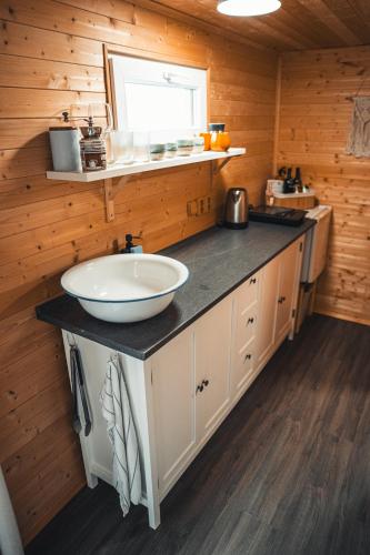 a bathroom with a sink and a counter in a cabin at Útulná maringotka uprostřed přírody pro dokonalý odpočinek ve dvou in Borovy