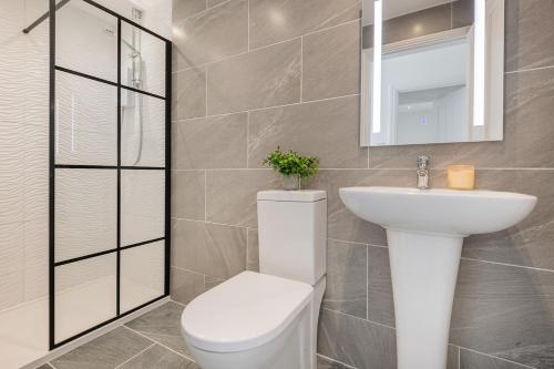 a bathroom with a white toilet and a sink at Gatehouse Cottage in Cartmel in Rossendale