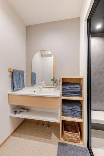 a bathroom with a sink and a mirror at 福宿美空 Fukuyado Misora in Fukuoka