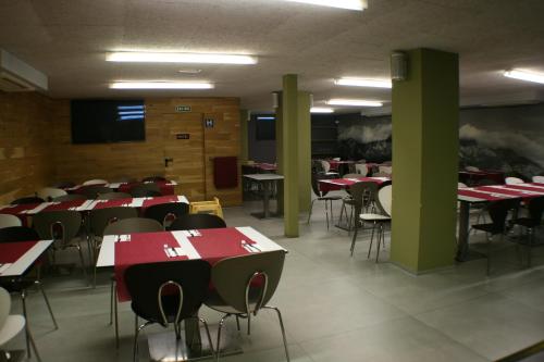 a dining room with red tables and chairs at Hotel Picos De Europa in Santander