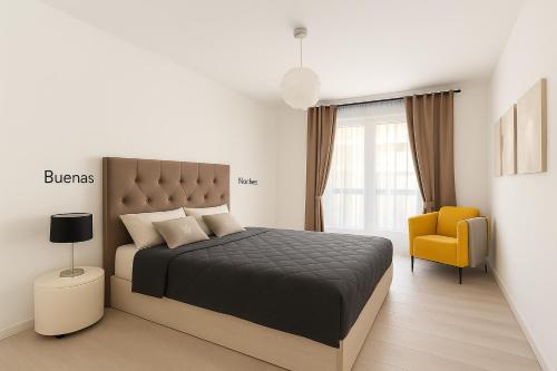 a bedroom with a bed and a yellow chair at Fairytale in Adeje in Adeje