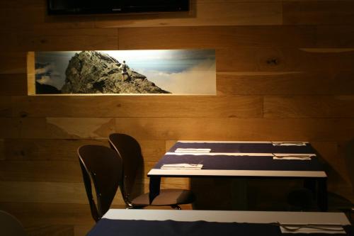 a dining room with a table and chairs with a picture on the wall at Hotel Picos De Europa in Santander