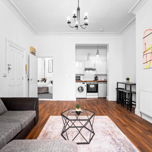 a living room with a couch and a table at Modern Apartment - Smart TV & Netflix 7PC in Wolverhampton