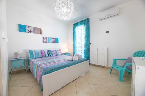 a bedroom with a bed and two blue chairs at Residence Tresor in Gallipoli