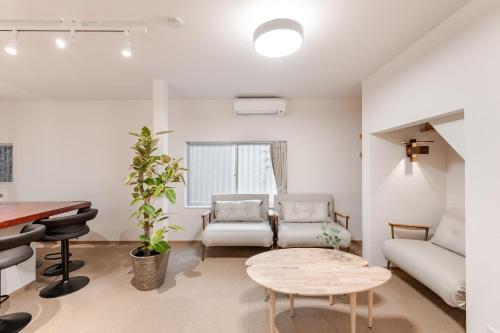 a living room with a couch and a table at 福宿美空 Fukuyado Misora in Fukuoka