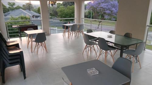 a room with tables and chairs and a balcony at Kliprivier Accommodation in Johannesburg
